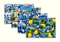 Four coordinated Tavola placemat designs fanned out — a preview of what a mystery drop can contain