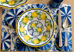 Coastal blue disposable paper placemat with Italian Amalfi village design on a set table